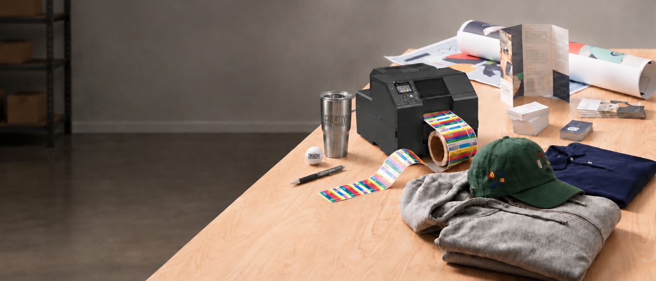 Label printer, printed materials, branded apparel, and promotional products on a workbench
